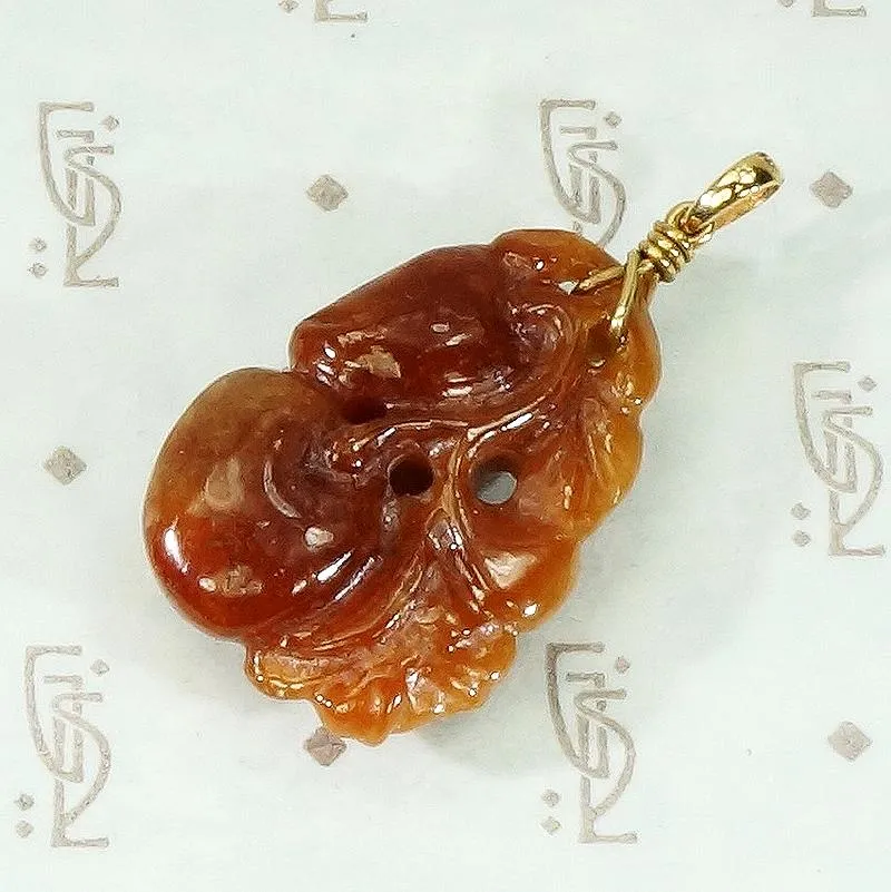 Plums and Cherries A Red Jade Carved Pendant