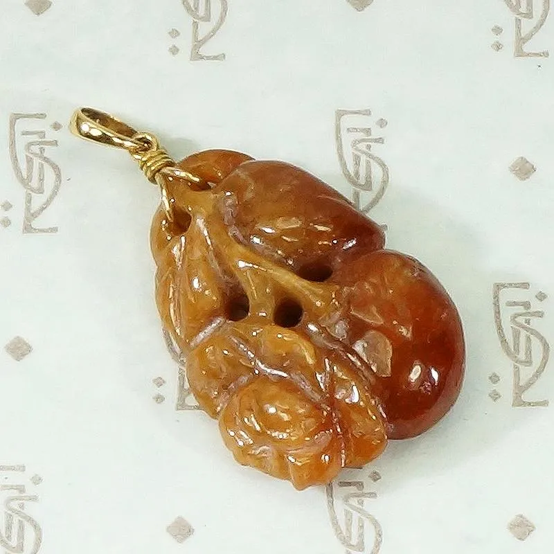 Plums and Cherries A Red Jade Carved Pendant