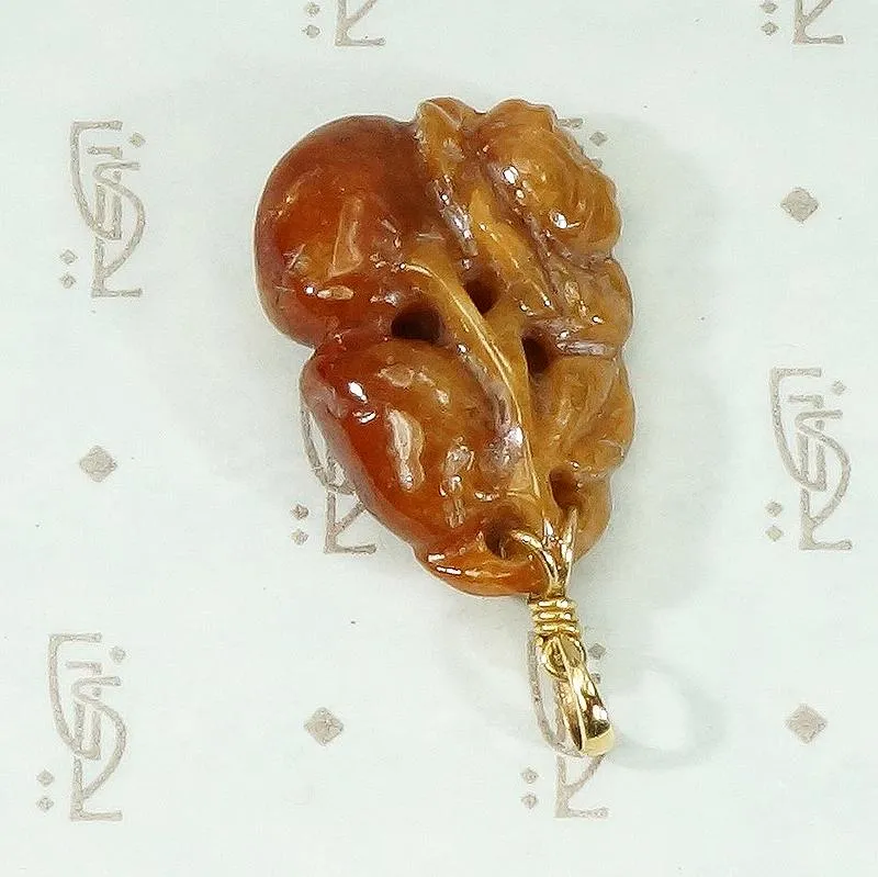 Plums and Cherries A Red Jade Carved Pendant