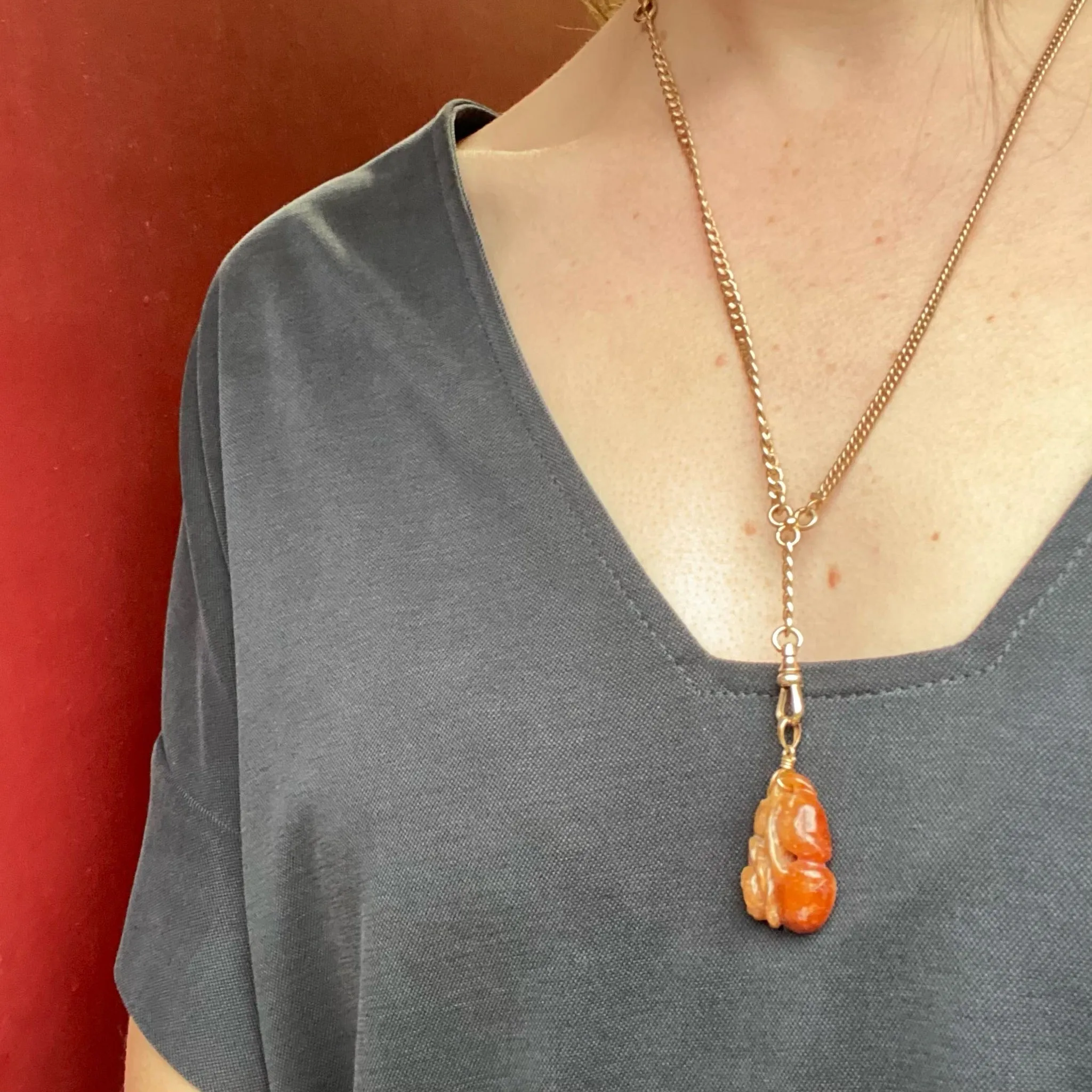Plums and Cherries A Red Jade Carved Pendant